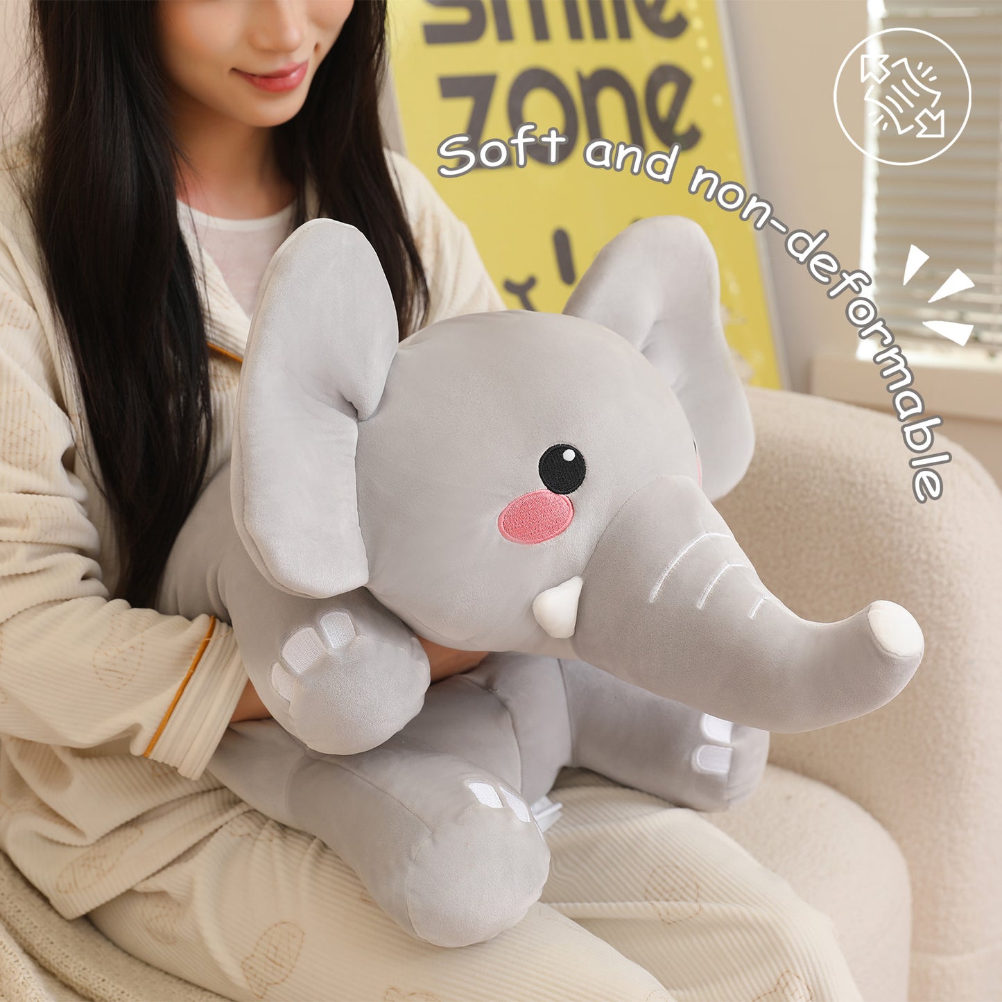 SQEQE weighted elephant stuffed animal held by an adult to show the compact plush size