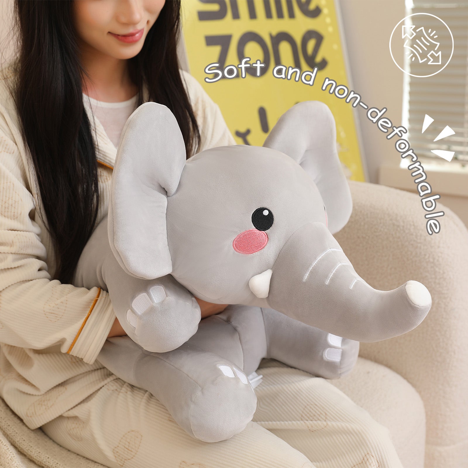 SQEQE weighted elephant stuffed animal held by an adult to show the compact plush size