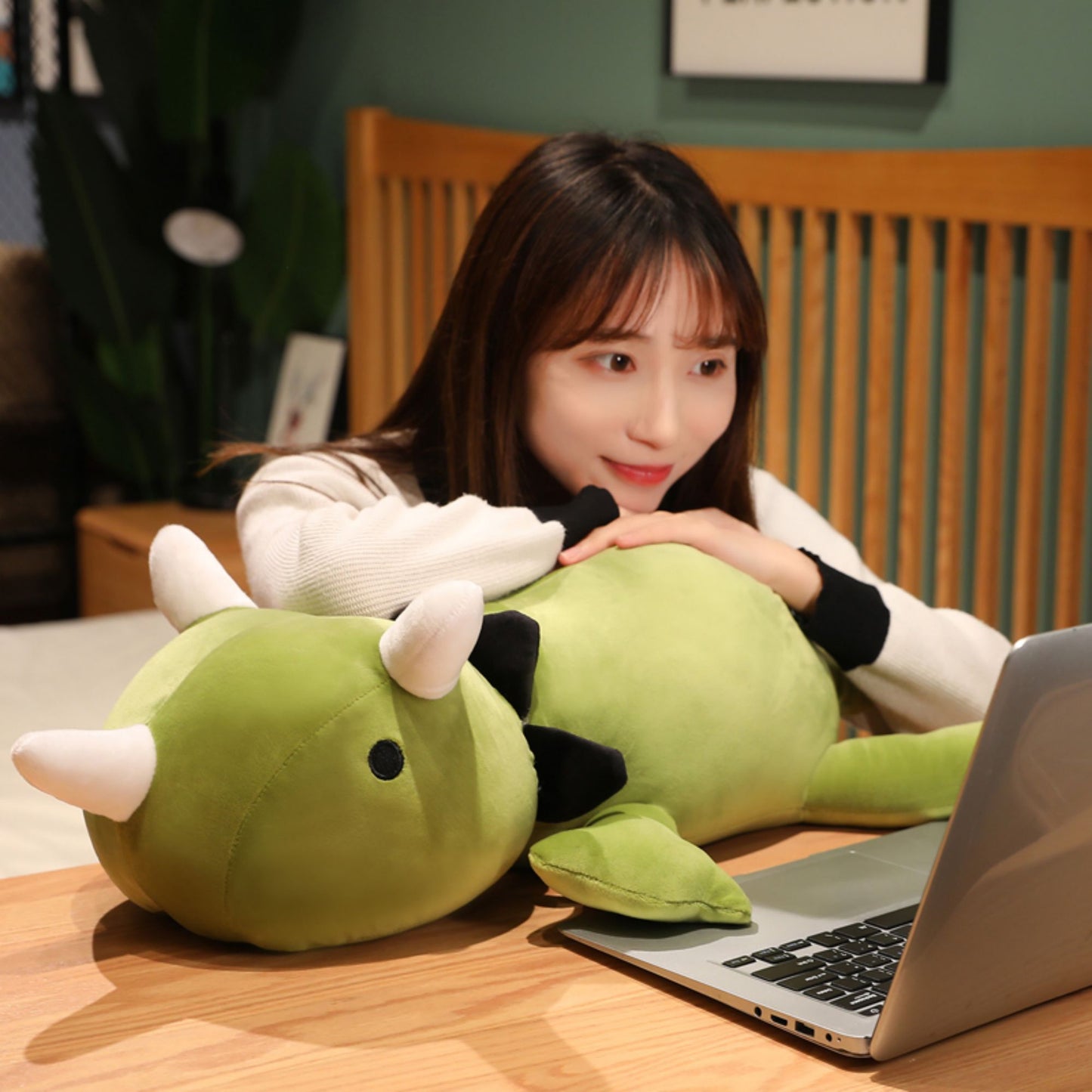 SQEQE giant triceratops stuffed animal carried by an adult to show the full body length