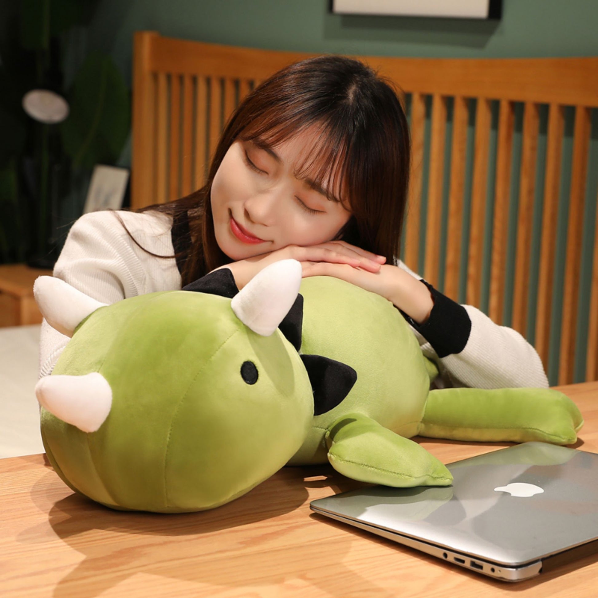 SQEQE giant triceratops stuffed animal hugged by an adult in a bedroom setting