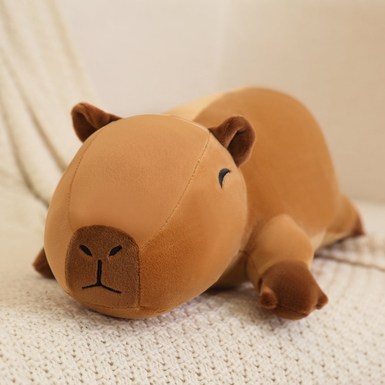 SQEQE capybara stuffed animal shown in a close home product display