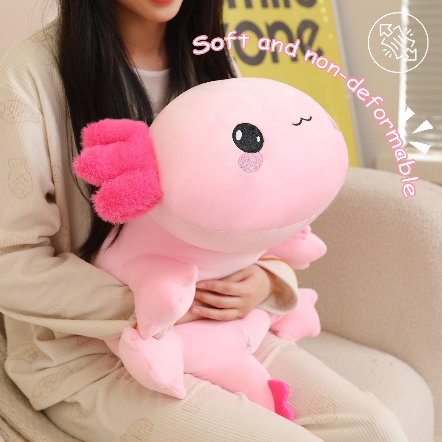 SQEQE weighted axolotl stuffed animal held by an adult to show the compact plush size