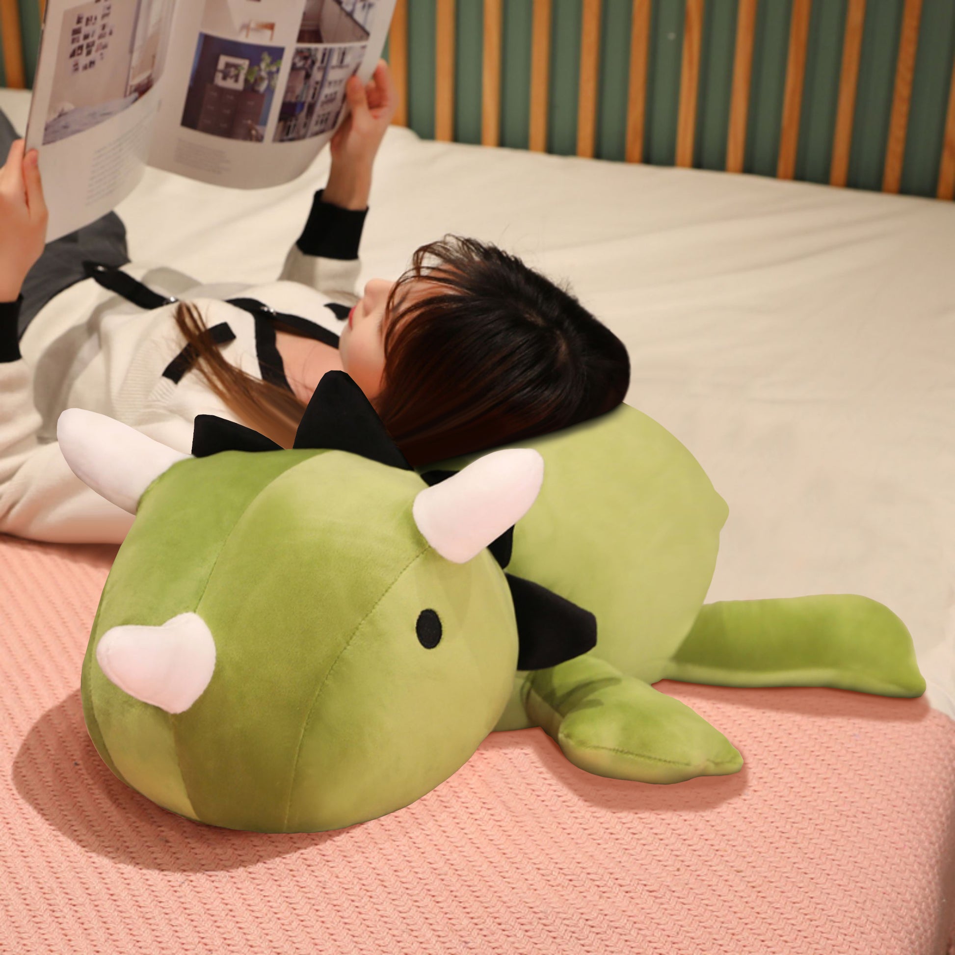 SQEQE giant triceratops stuffed animal held by an adult to demonstrate the large plush size